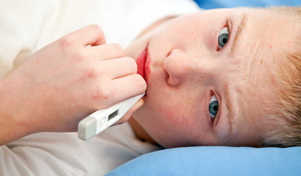 boy learning how to take temperature