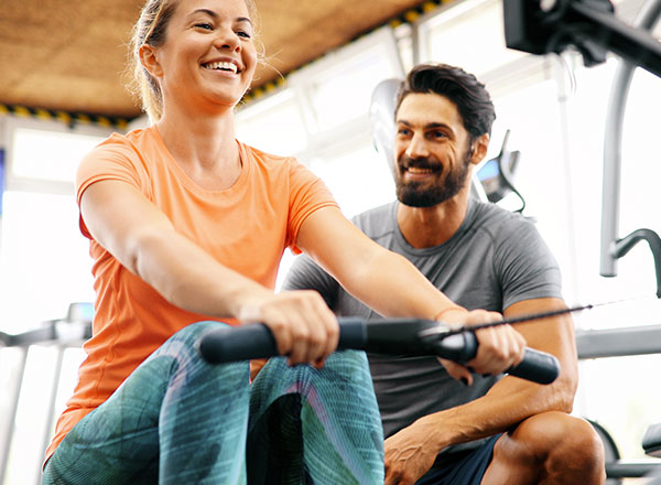 Woman exercising with personal trainer