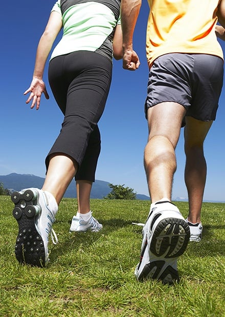 Healthy couple walking in grass