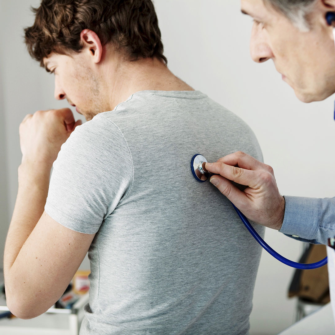 Doctor helping a patient with a cough