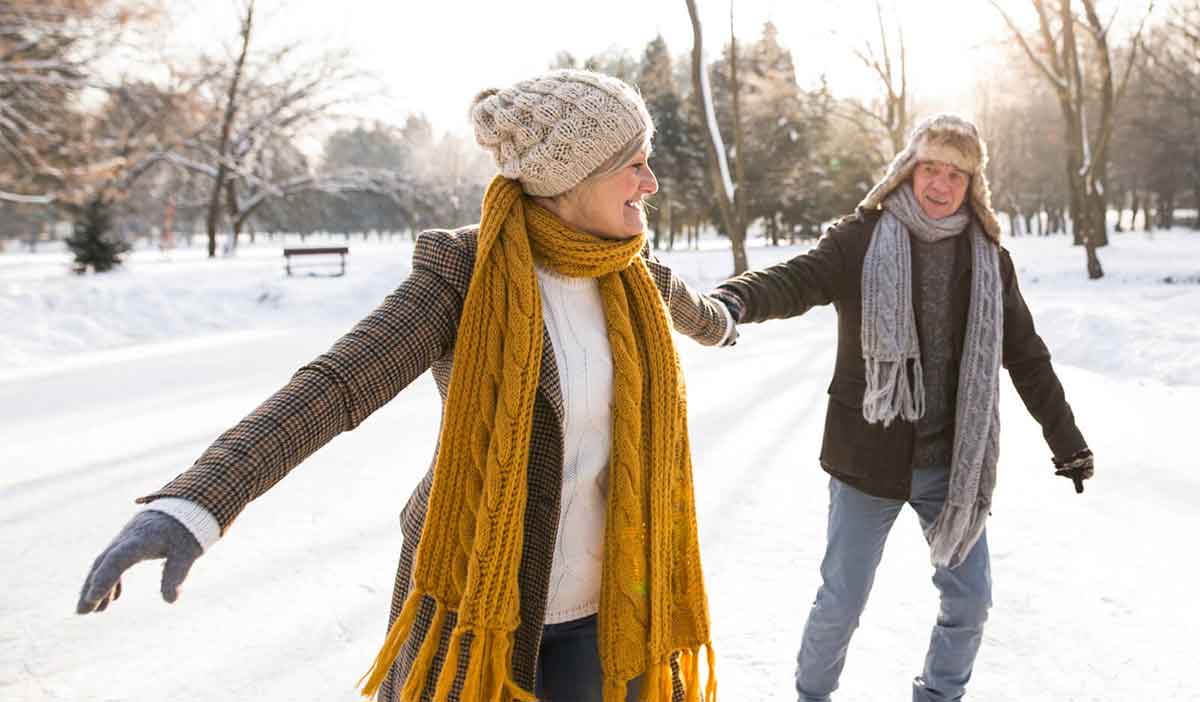 Older couple exercises outside in the snow