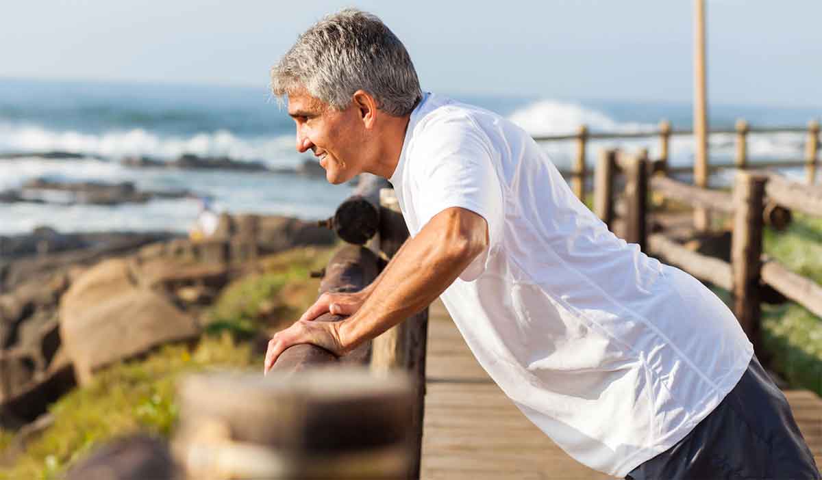 Senior man warms up and stretches before exercising