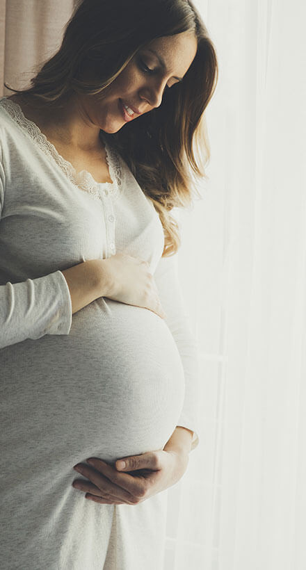 pregnant woman holding stomach