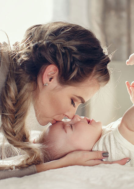 mom kissing baby