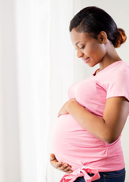 pregnant woman holding stomach